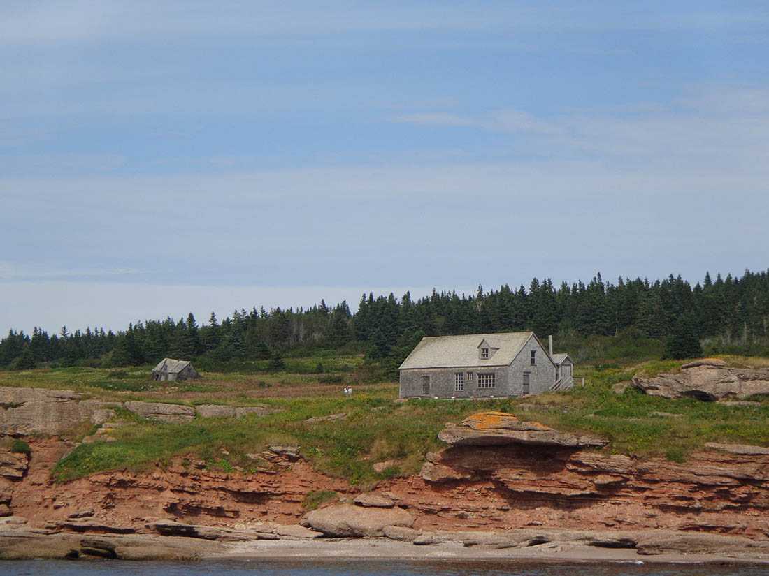 House by a red cliff.