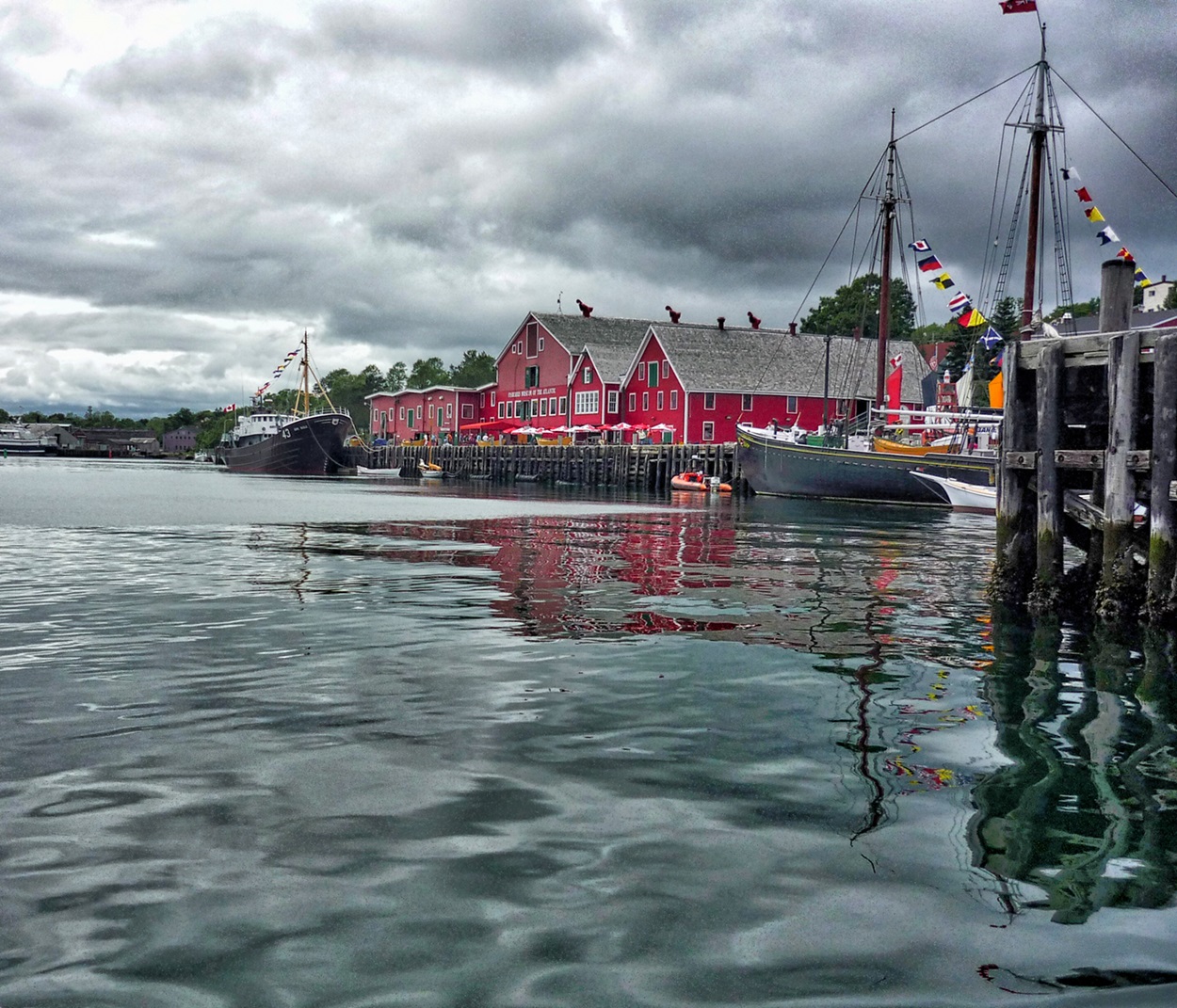 Red building and wharf by the water.